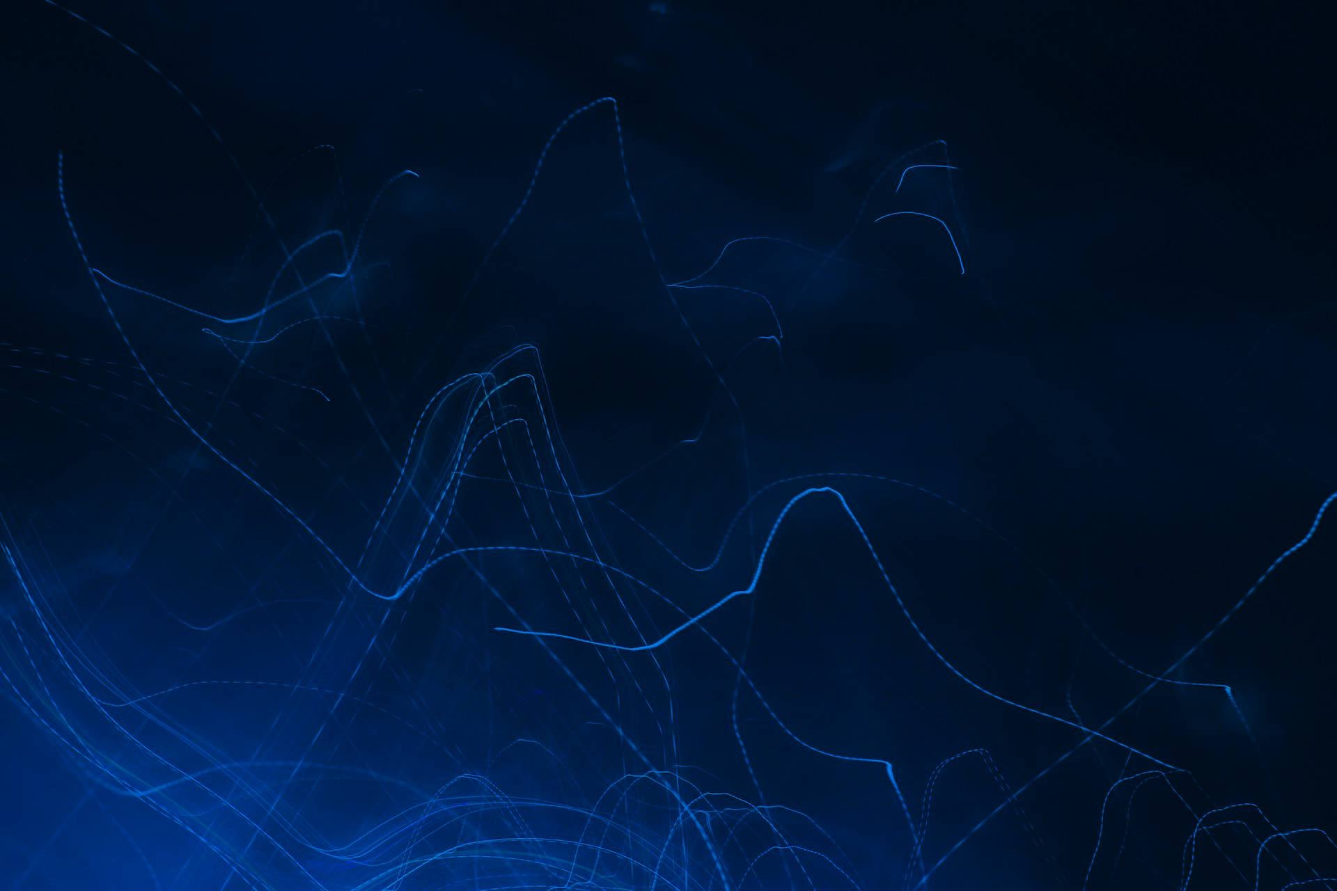 Abstract blue wave pattern on a dark background