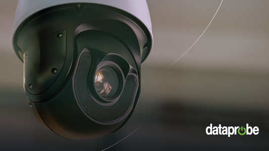 A close-up shot of a black and dark gray dome security camera with a white top housing, set against a blurred background. A 'dataprobe' watermark is visible in the bottom right corner.