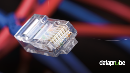 A close-up of a clear RJ45 Ethernet connector showing internal gold pins and multicolored wire colors, with blurred red and blue cables in the background and a 'dataprobe' watermark in the lower right.